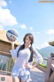 A woman holding a basketball on a balcony.