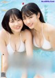 A couple of women in white bikinis in a swimming pool.