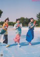 A group of young women playing with water guns on an ice rink.