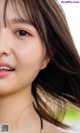 A close up of a woman with long brown hair.