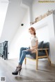 A woman sitting on a chair in a room.