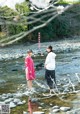 A couple of women standing next to each other in a river.